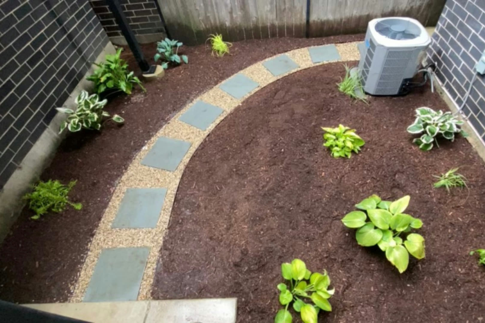 Stepping-stone path with mulched garden beds